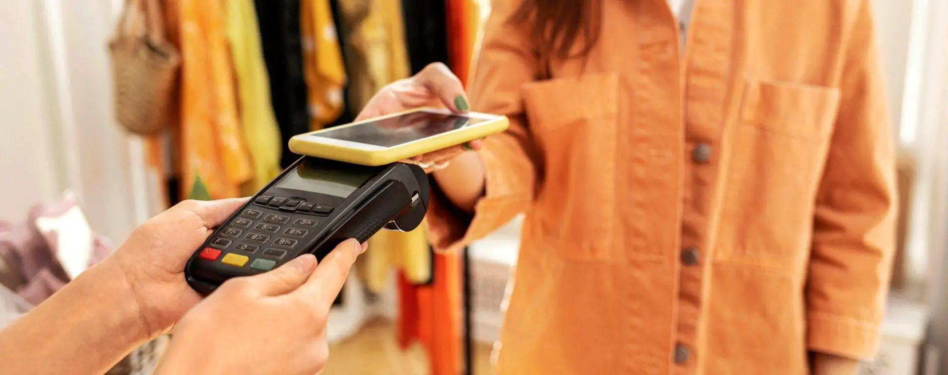 A person paying for something with their cell phone.