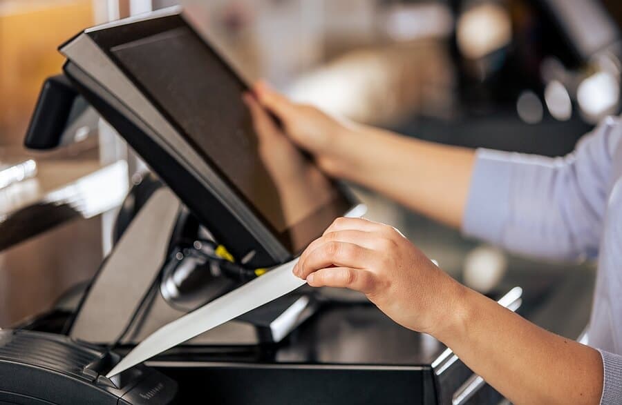 A person using a computer on top of a table.