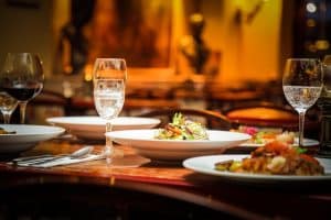 A table with plates and glasses of wine.