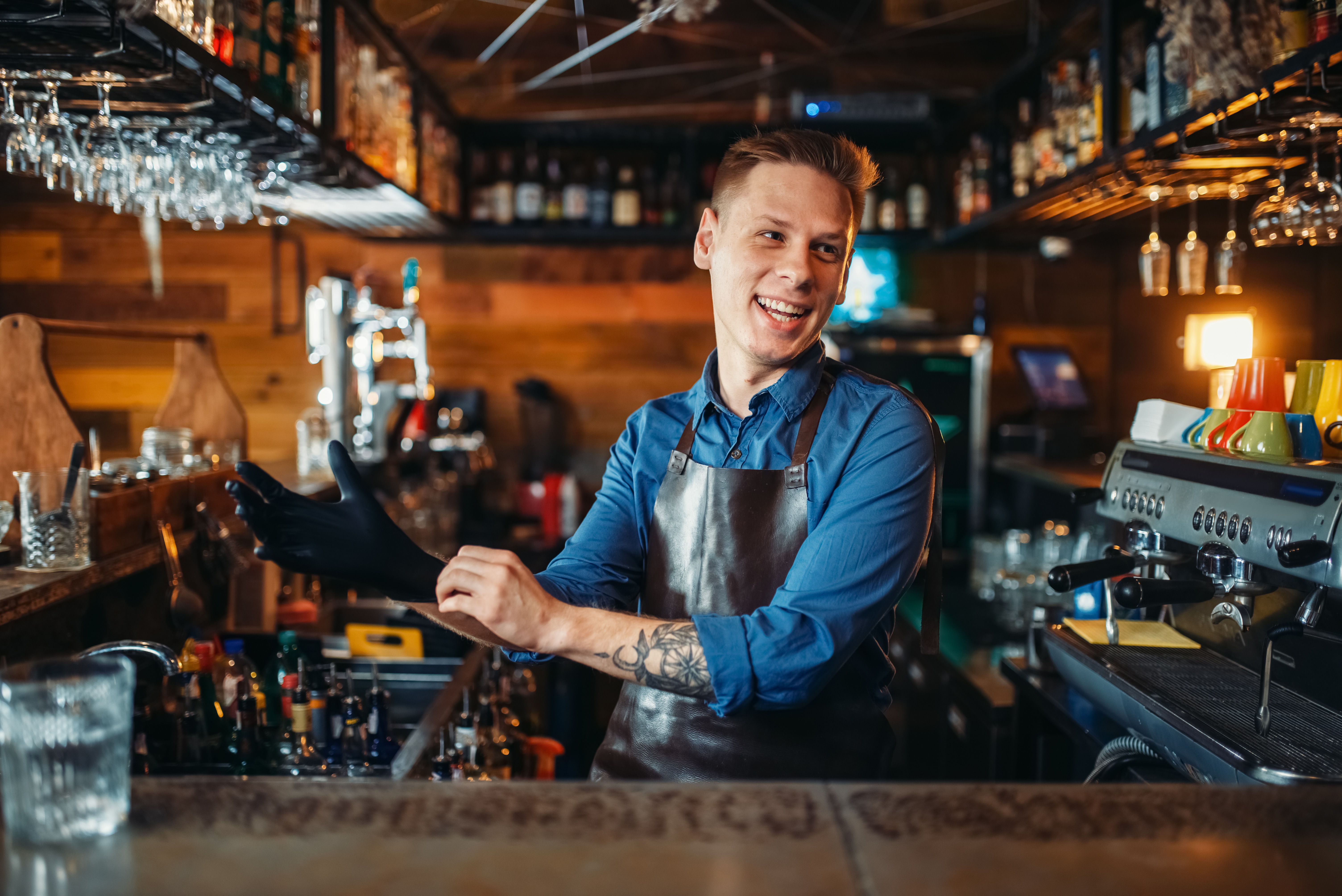 A man sitting at the bar smiling for the camera.