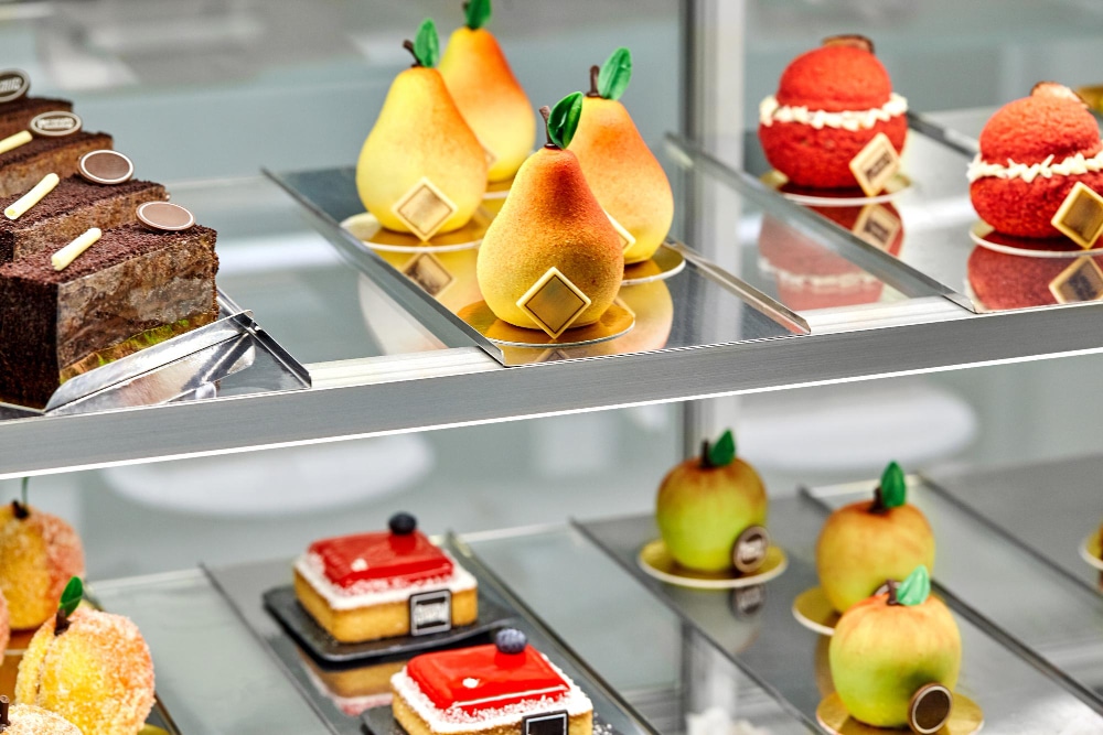 A display case filled with different types of desserts.