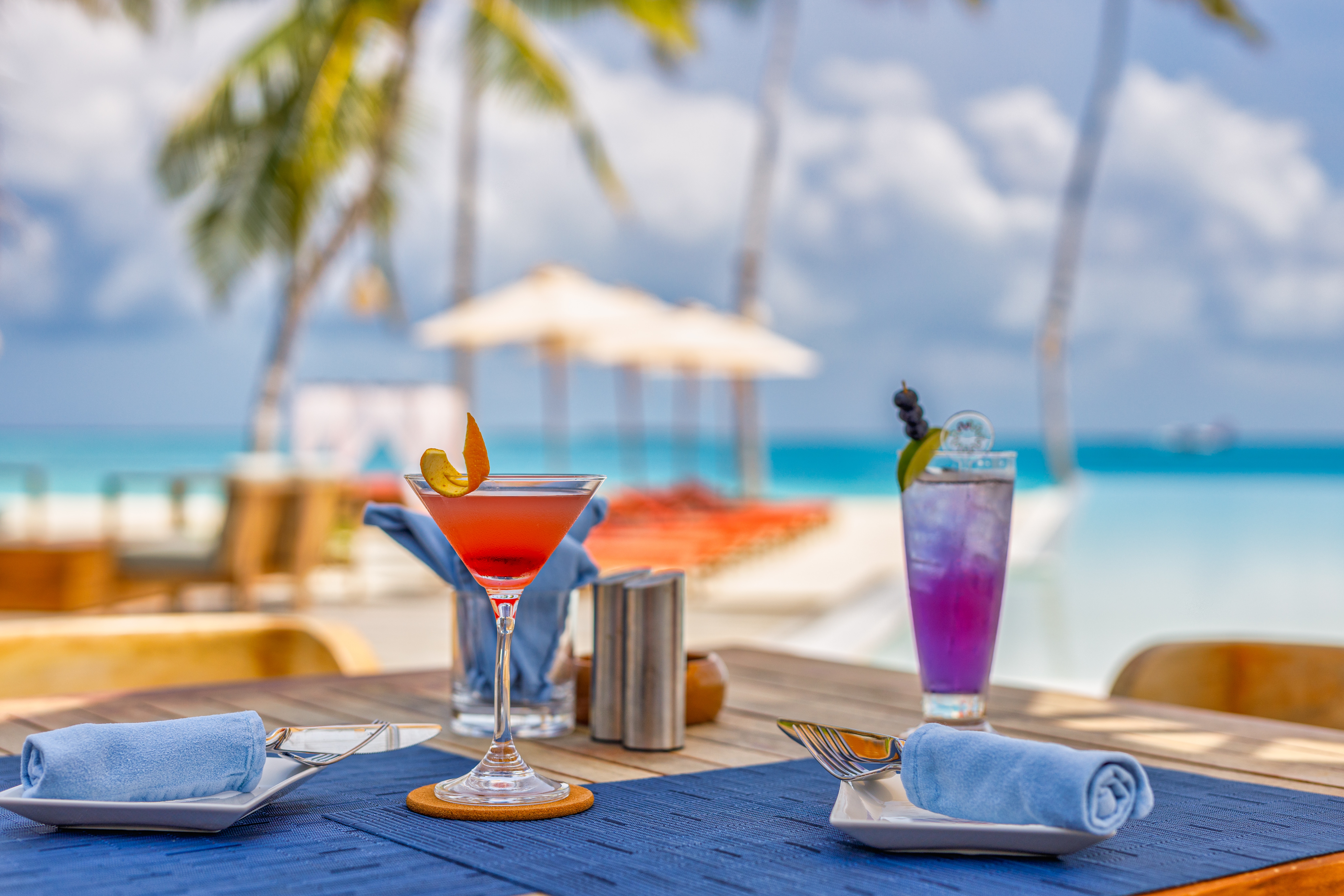 A table with two glasses of cocktails on it