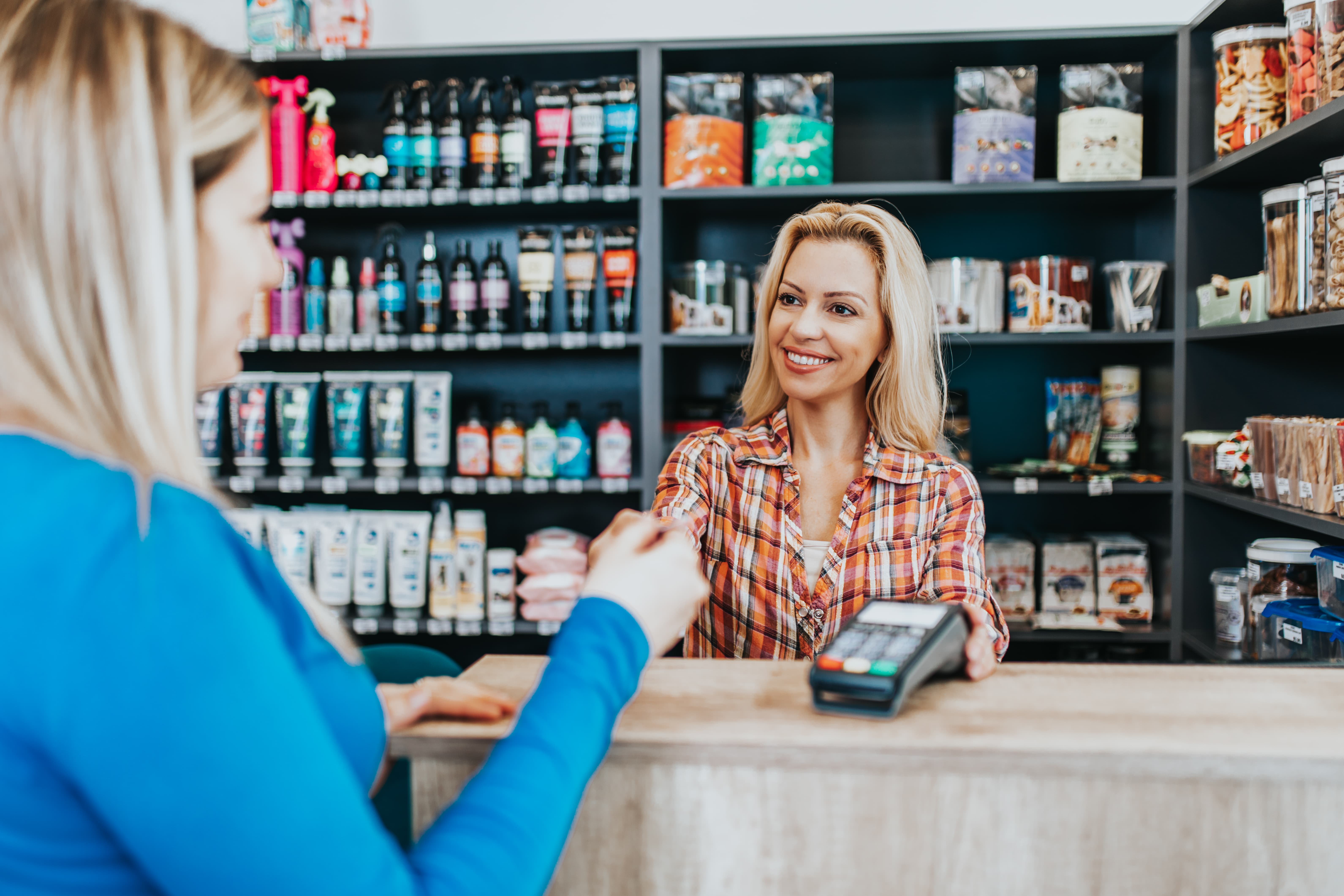 A woman sitting at the counter of a store