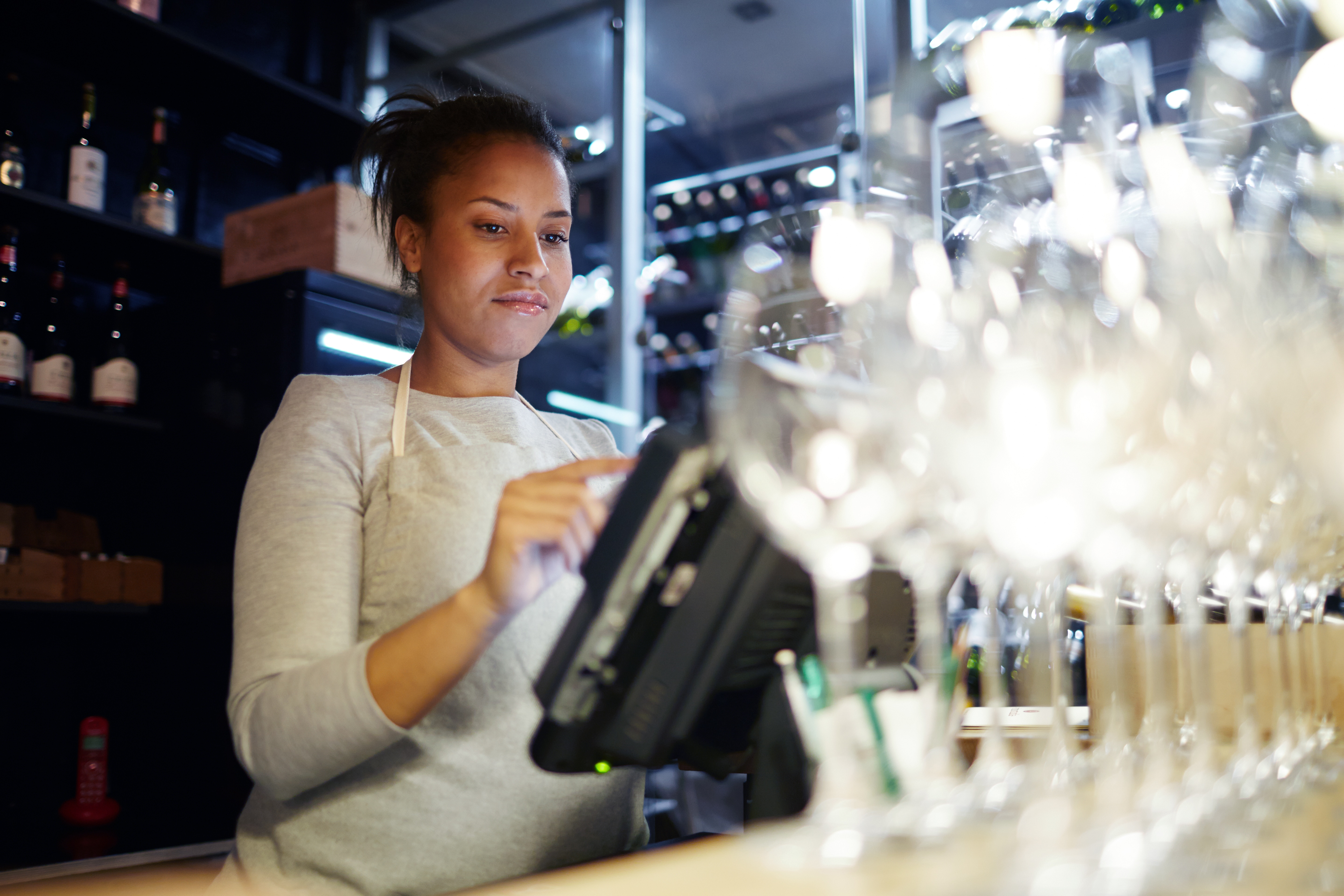 A woman is working at the bar